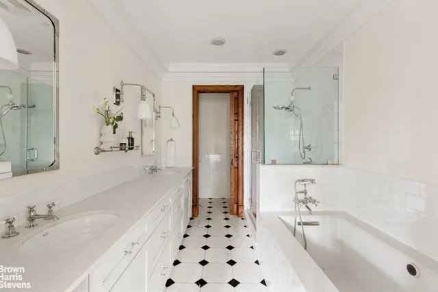 a bathroom with a bathtub sink and mirror