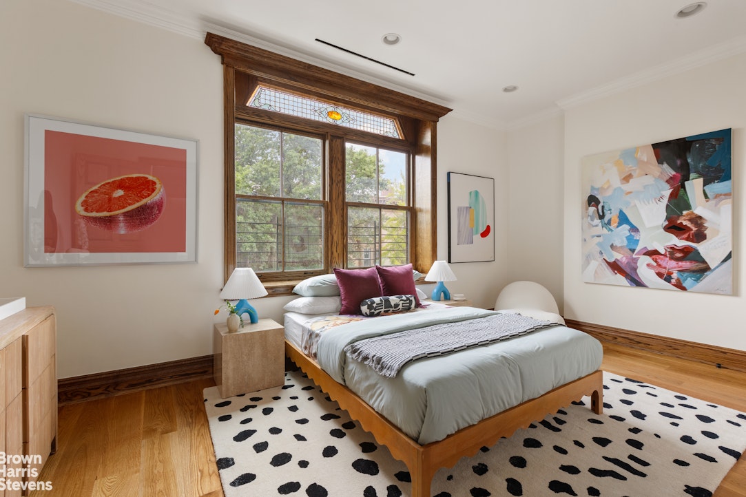 577 Jefferson Avenue Brooklyn, NY 11221 - Photo 13 of 16 a bedroom with a bed and a window