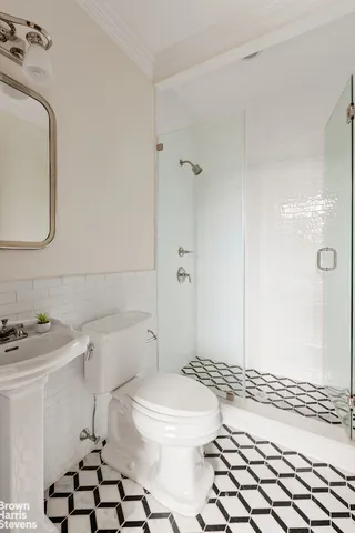 a bathroom with a sink toilet and shower