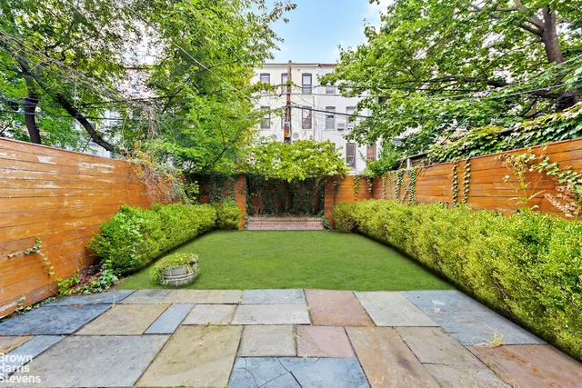 a view of backyard with a garden and plants