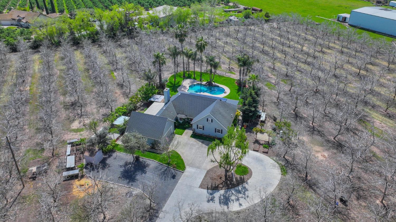 an aerial view of a house with a yard and a outdoor space