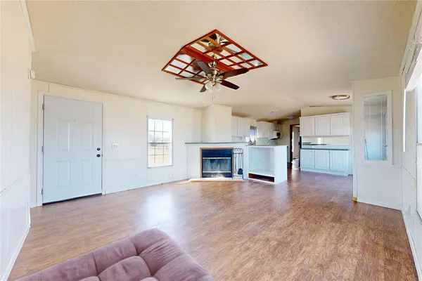 a view of a livingroom with a fireplace and window
