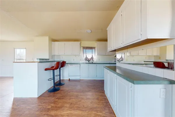 a kitchen with kitchen island granite countertop a sink and counter top space