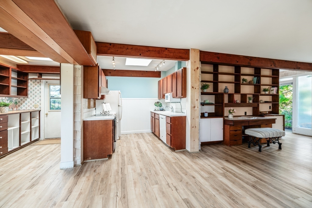 4 Irvana Road Rockport, MA 01966 - Photo 9 of 34 a room with stainless steel appliances kitchen island granite countertop a refrigerator a stove a sink dishwasher and white cabinets with wooden floor