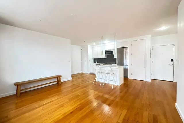 a view of kitchen with cabinets and wooden floor