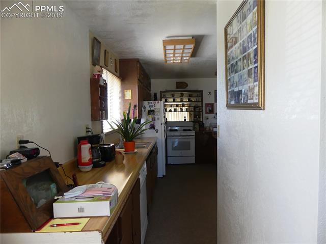 30250 Antioch Road Yoder, CO 80864 - Photo 3 of 10 Hallway from back porch into kitchen