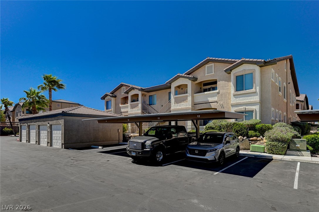8985 South Durango Drive, Unit 2187 Las Vegas, NV 89113 - Photo 56 of 73 Secure covered parking and detached garages complement this inviting multi-level building with desert landscaping.