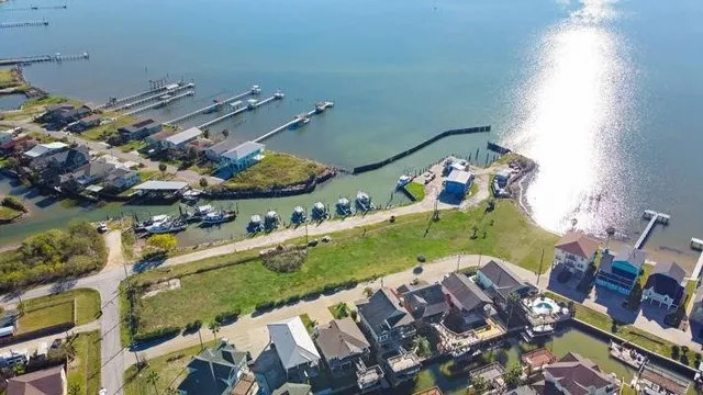 an aerial view of a house with a lake view