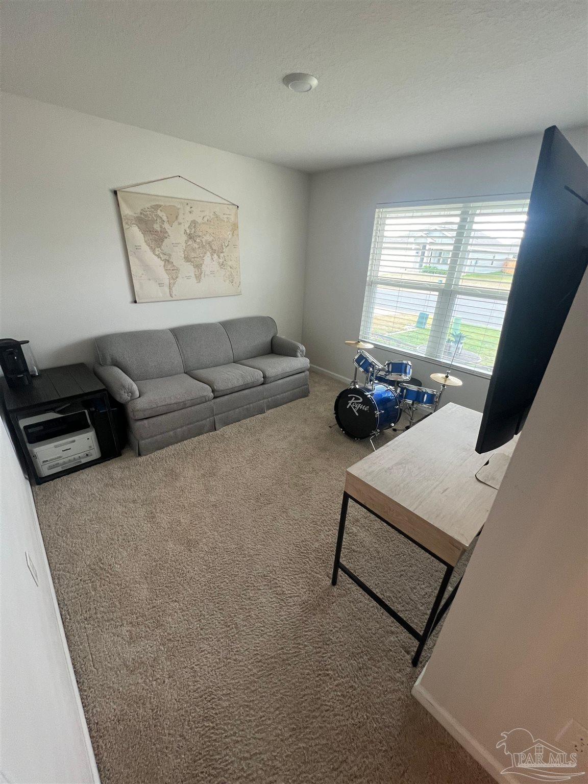 5253 Peach Drive Pace, FL 32571 - Photo 12 of 23 a living room with furniture and a large window