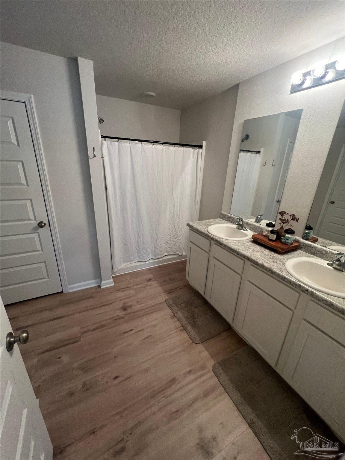 5253 Peach Drive Pace, FL 32571 - Photo 13 of 23 a room with a sink and a mirror