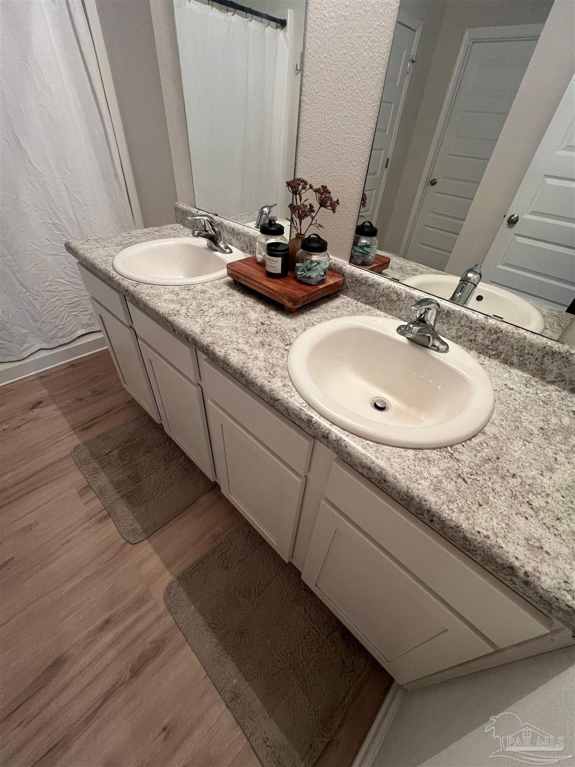 5253 Peach Drive Pace, FL 32571 - Photo 15 of 23 a bathroom with a granite countertop sink and a mirror
