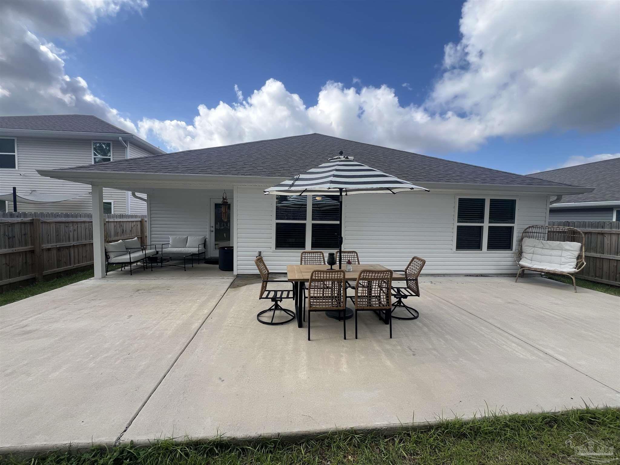 5253 Peach Drive Pace, FL 32571 - Photo 16 of 23 a view of a house with furniture and a yard