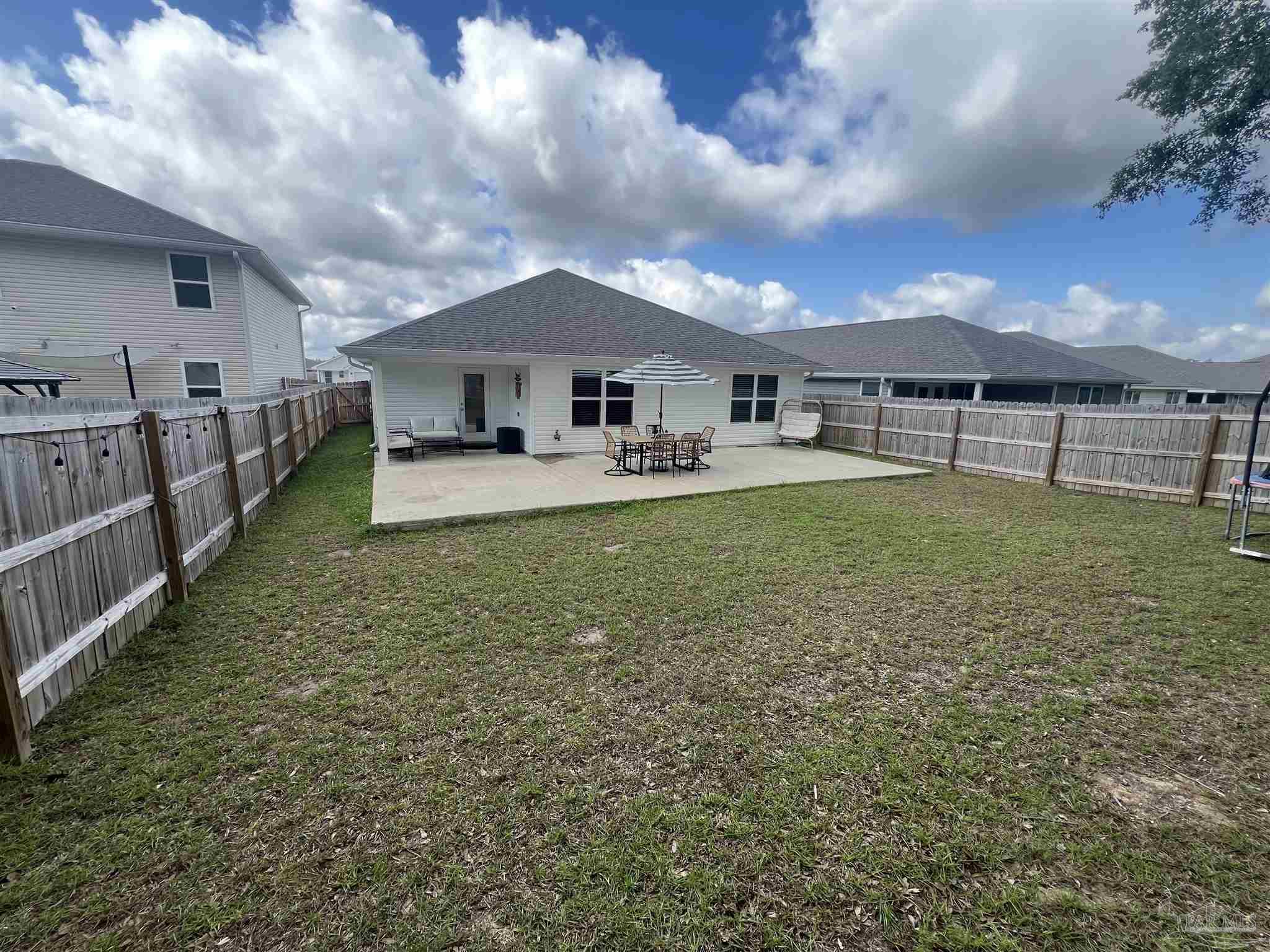 5253 Peach Drive Pace, FL 32571 - Photo 18 of 23 a view of a house with a yard and sitting area