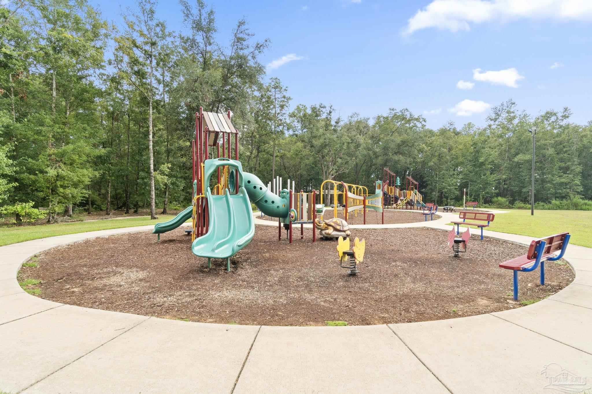 5253 Peach Drive Pace, FL 32571 - Photo 20 of 23 a view of a park with swings