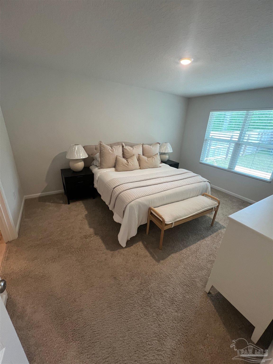 5253 Peach Drive Pace, FL 32571 - Photo 10 of 23 a spacious bedroom with a bed and a large window