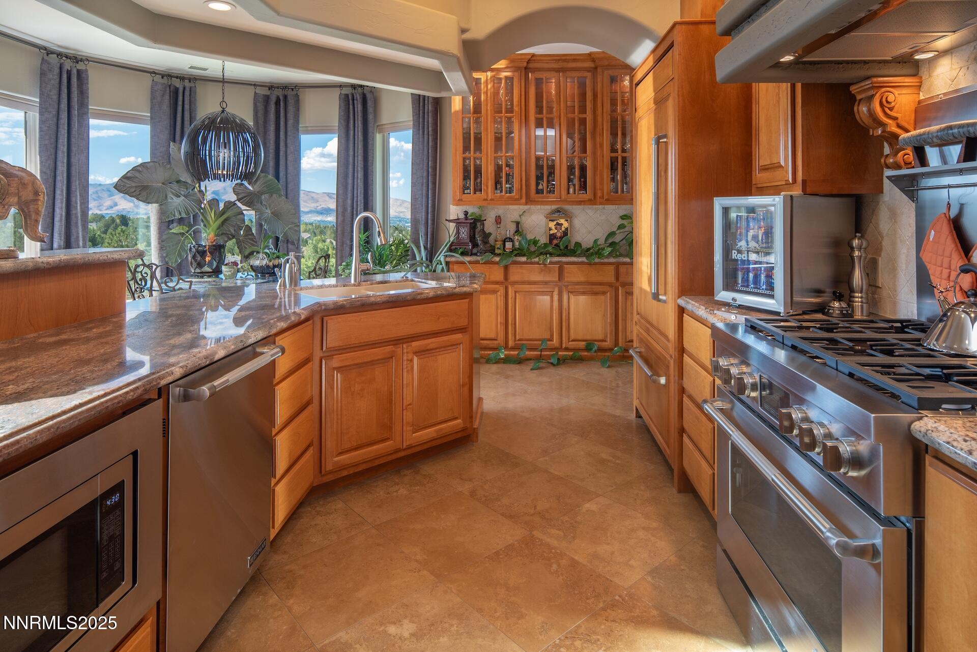 4905 Mountainshyre Road Reno, NV 89519 - Photo 13 of 64 a kitchen with stainless steel appliances granite countertop a stove and a sink