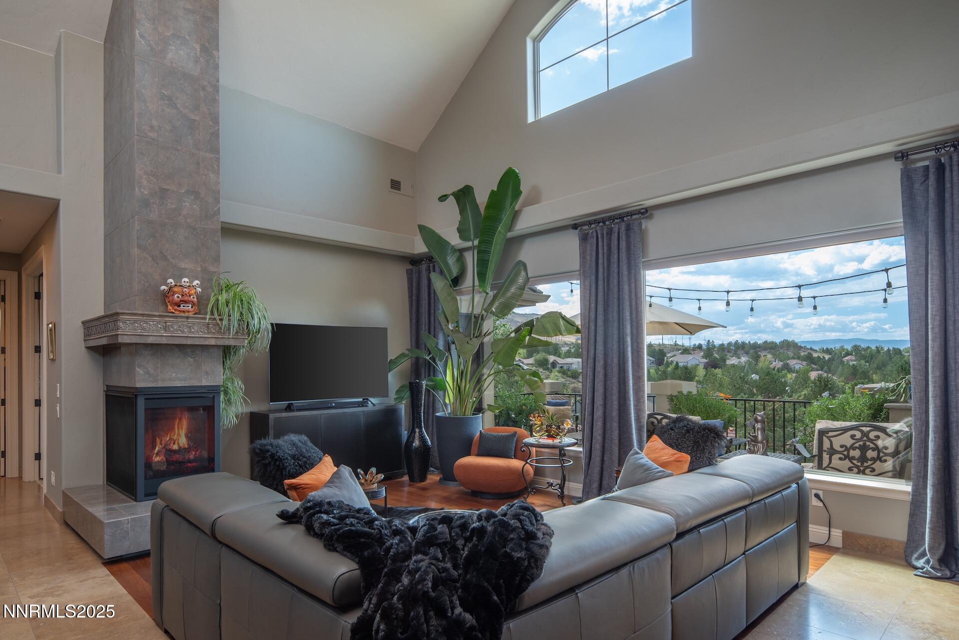 4905 Mountainshyre Road Reno, NV 89519 - Photo 5 of 64 a living room with furniture a fireplace and a floor to ceiling window