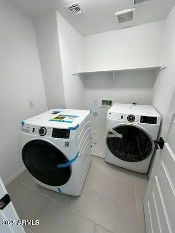 a utility room with washer and dryer