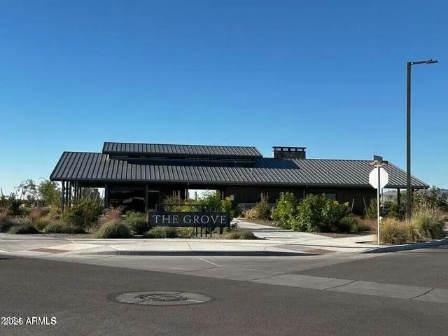 a living room with couches a fireplace and a dining table with a large window