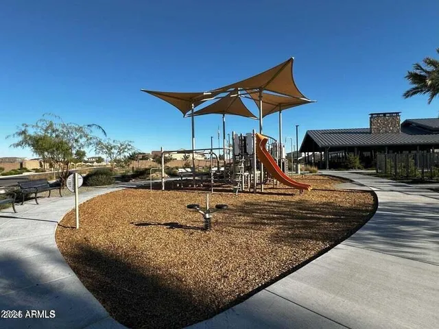 a view of swimming pool with a lounge chairs