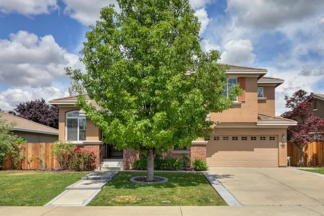 a living room with furniture chandelier and a fireplace