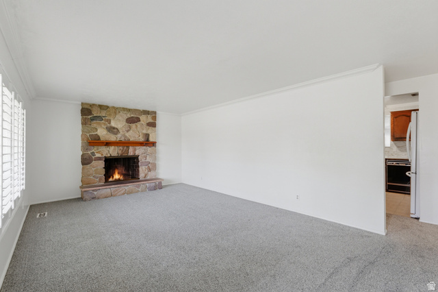148 Tennyson Avenue Sandy, UT 84070 - Photo 5 of 55 Living area featuring a floor-to-ceiling stone fireplace with a wood mantel
