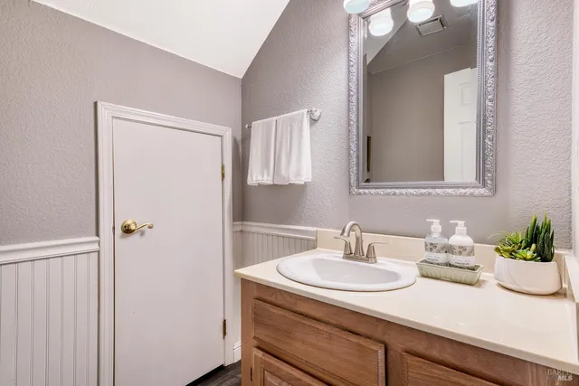a bathroom with a sink a vanity and a mirror