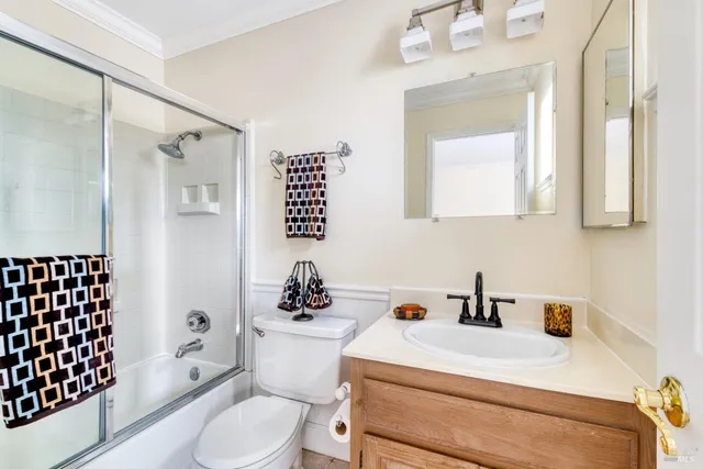a bathroom with a sink toilet a mirror and shower