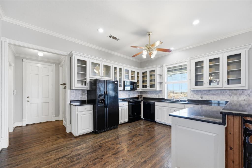 707 Cullins Road Rockwall, TX 75032 - Photo 11 of 40 a kitchen with stainless steel appliances granite countertop a refrigerator stove top oven and sink