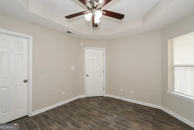 a bathroom with a tub sink vanity and mirror