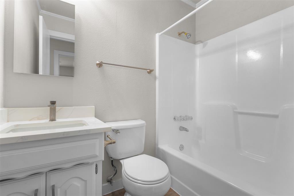 701 Rosehill Road Terrell, TX 75160 - Photo 11 of 20 a bathroom with a sink a toilet and shower