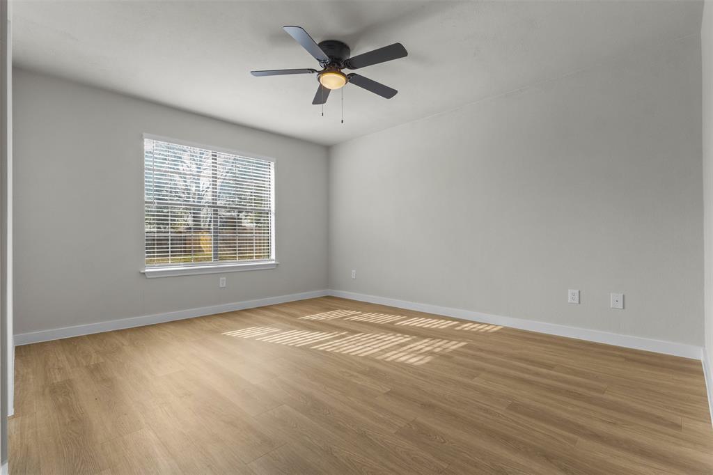 701 Rosehill Road Terrell, TX 75160 - Photo 13 of 20 an empty room with a window and a ceiling fan