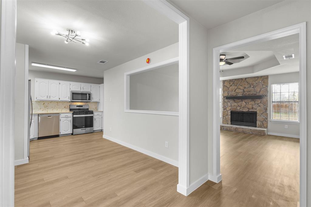701 Rosehill Road Terrell, TX 75160 - Photo 3 of 20 a view of a kitchen with a sink stove cabinets and empty room