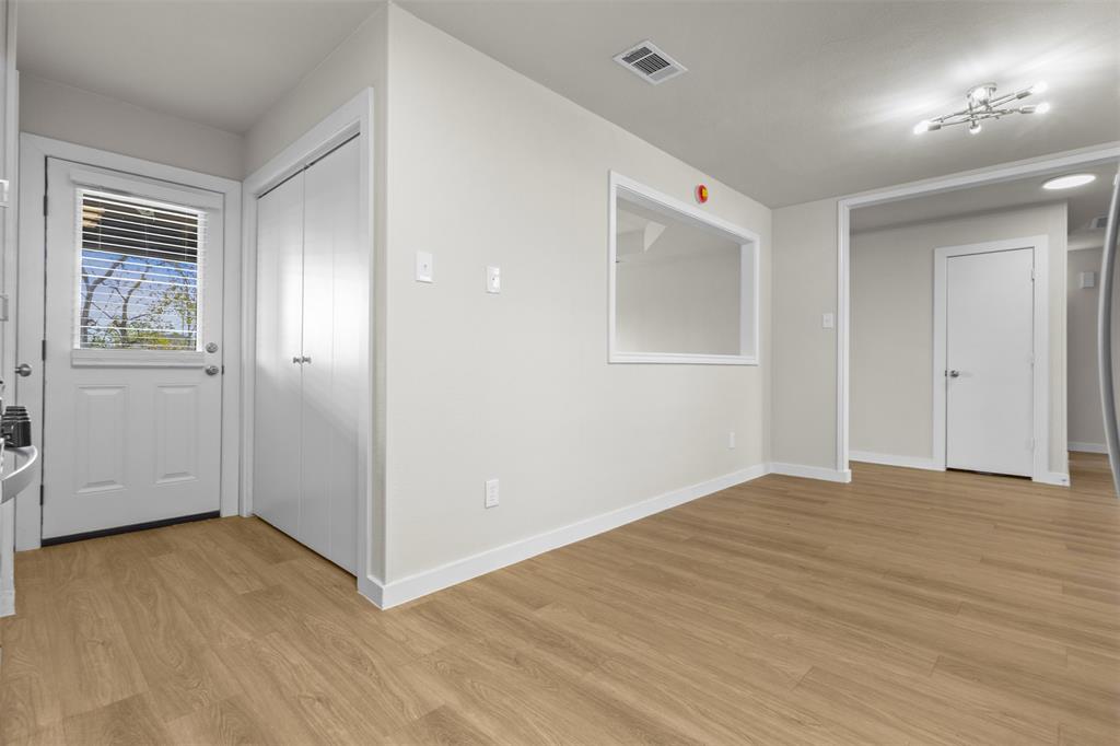 701 Rosehill Road Terrell, TX 75160 - Photo 6 of 20 a view of an empty room with wooden floor and a window
