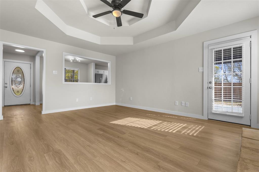 701 Rosehill Road Terrell, TX 75160 - Photo 8 of 20 a view of an empty room with a window and wooden floor