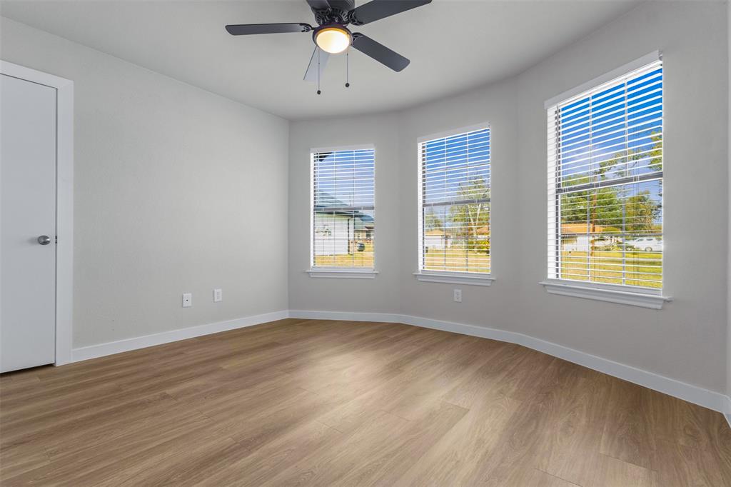 701 Rosehill Road Terrell, TX 75160 - Photo 9 of 20 a view of an empty room with wooden floor and a window