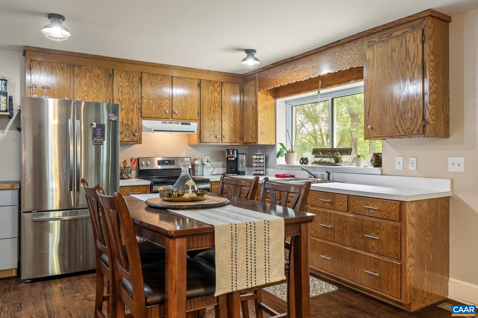 1376 Wyatt Mountain Road Dyke, VA 22935 - Photo 71 of 75 a kitchen with a refrigerator a sink a stove and chairs