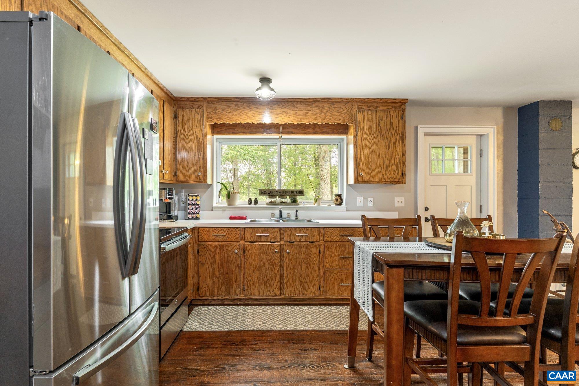 1376 Wyatt Mountain Road Dyke, VA 22935 - Photo 72 of 75 a kitchen with stainless steel appliances granite countertop a refrigerator a sink a stove and white cabinets with wooden floor