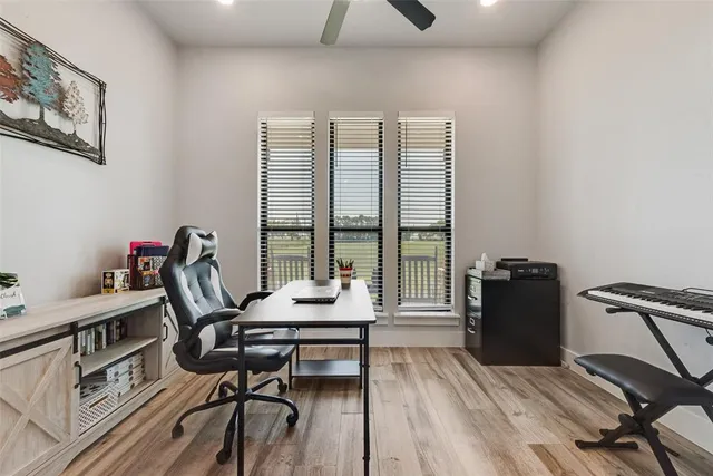 a view of a workspace with furniture and a window
