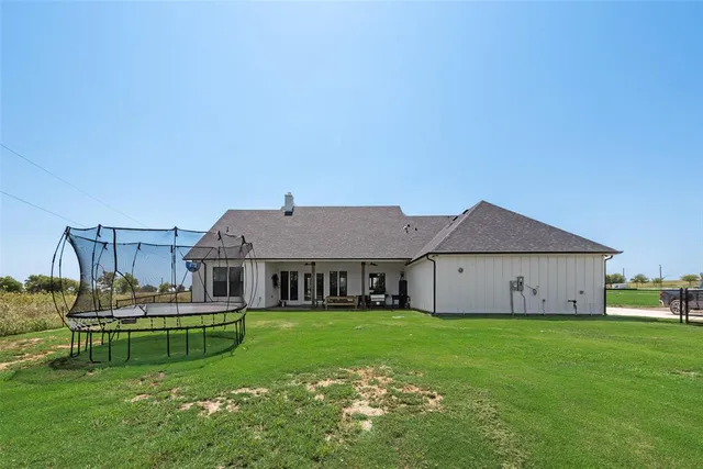 a aerial view of a house with a yard and sitting area