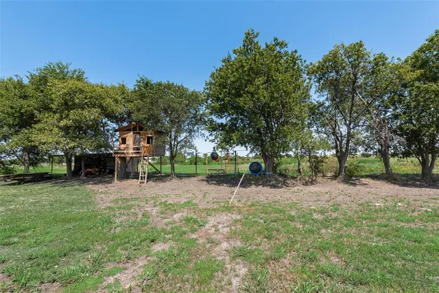 a backyard of a house with table and chairs