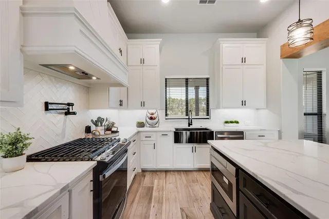 a kitchen with a sink stove and cabinets