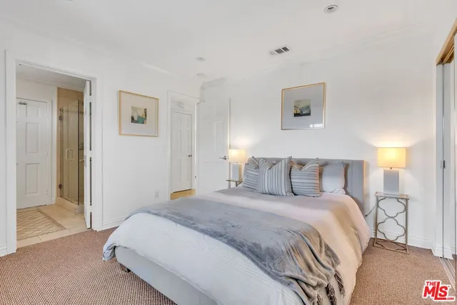 a bedroom with a bed and a night stand