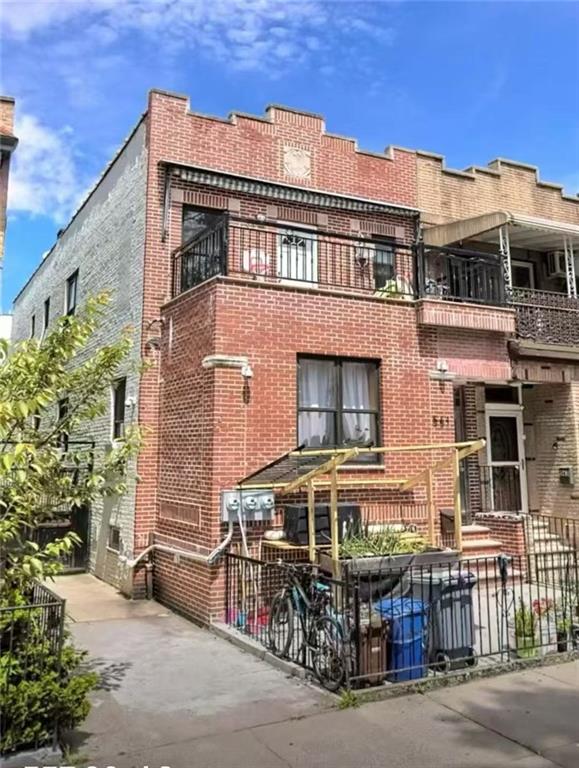 561 83rd Street Brooklyn, NY 11209 - Photo 1 of 6 a front view of a building with glass windows and a table