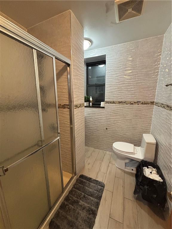 561 83rd Street Brooklyn, NY 11209 - Photo 5 of 6 a bathroom with a toilet and a shower