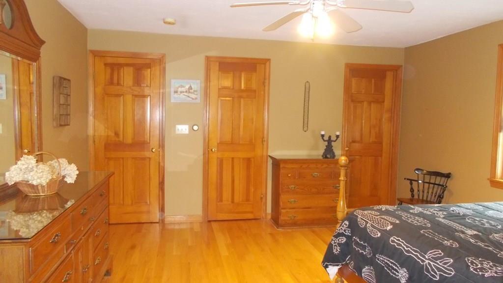 52 S Road Templeton, MA 01468 - Photo 17 of 41 a bedroom with a bed and a chandelier