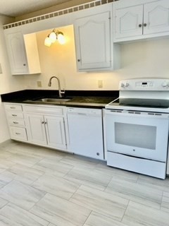 40 Village Road, Unit 610 Middleton, MA 01949 - Photo 10 of 36 a kitchen with a sink stove and cabinets