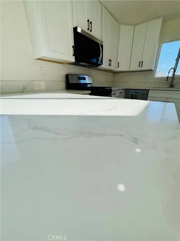 a kitchen with a sink and a microwave