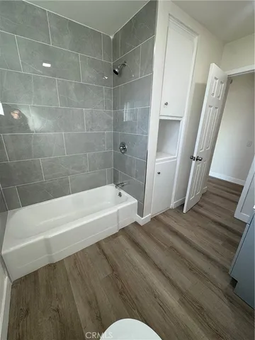 a bathroom with a bathtub and shower