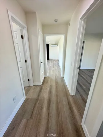 a view of a hallway view with wooden floor and staircase